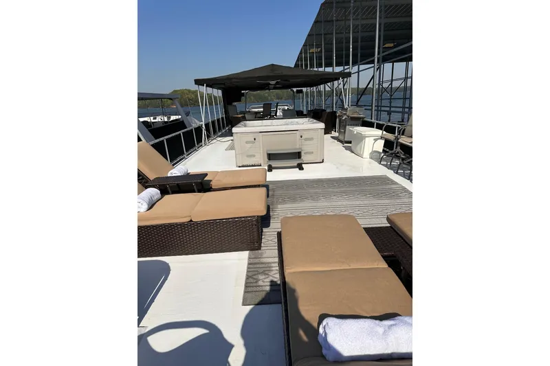 Slide: The Image of Luxurious 2008 Starlite 18x85 houseboat deck with sun loungers and shaded seating area. - 19