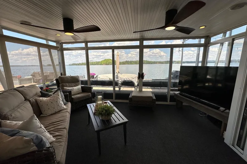 Slide: The Image of Luxurious 2008 Starlite 18x85 houseboat interior with lake view, cozy seating, and modern decor. - 2