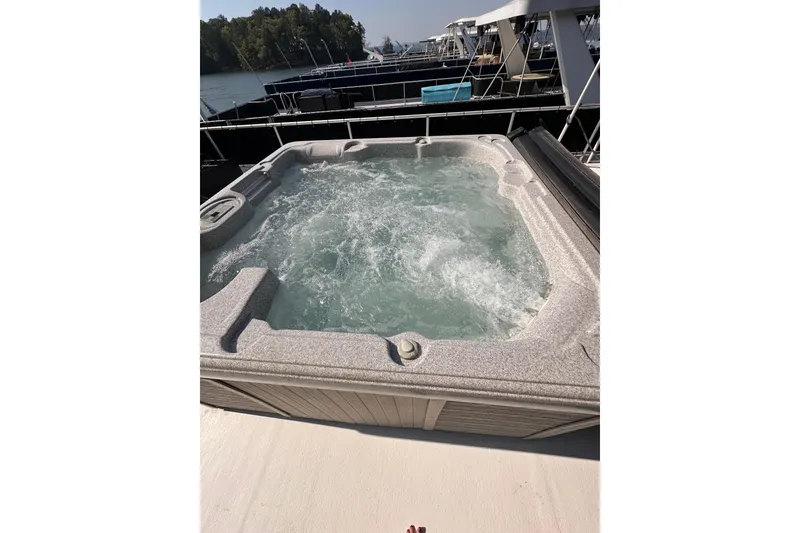 Slide: The Image of Hot tub on 2008 Starlite 18x85 houseboat, docked with other boats in the background. - 20