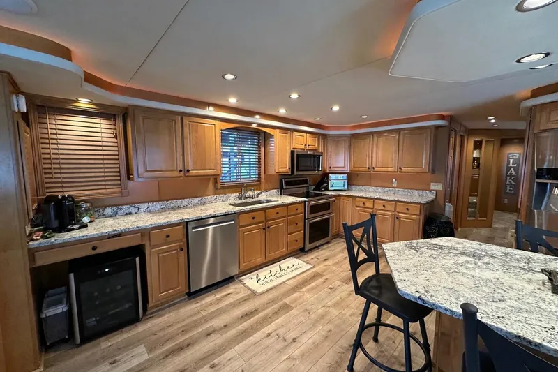 Slide: The Image of Spacious kitchen in 2008 Starlite 18x85 houseboat with wooden cabinets and granite countertops. - 5
