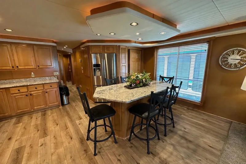 Slide: The Image of Luxurious kitchen in 2008 Starlite 18x85 houseboat with island, wooden cabinets, and modern appliances. - 6