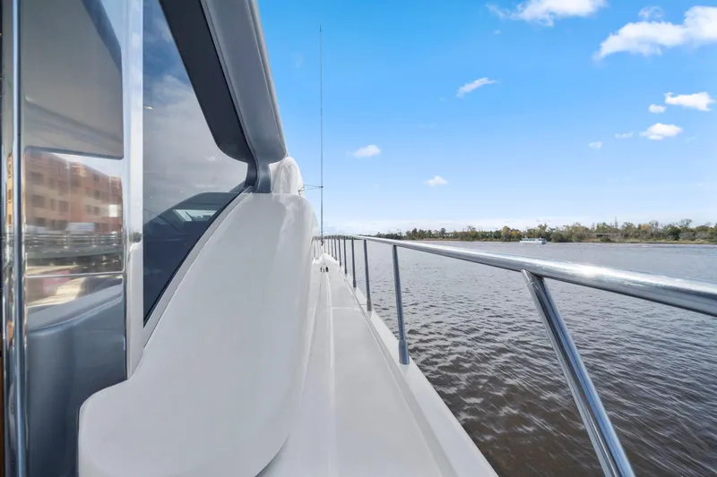 Slide: The Image of Side view of 2010 Mangusta 72 Express yacht on calm water under blue sky. - 10