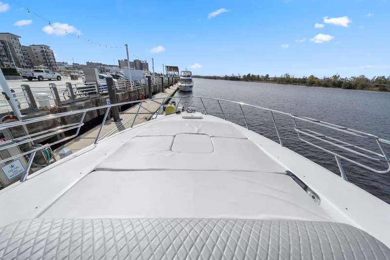 Slide: The Image of 2010 Mangusta 72 Express yacht docked at a marina with clear blue skies. - 12