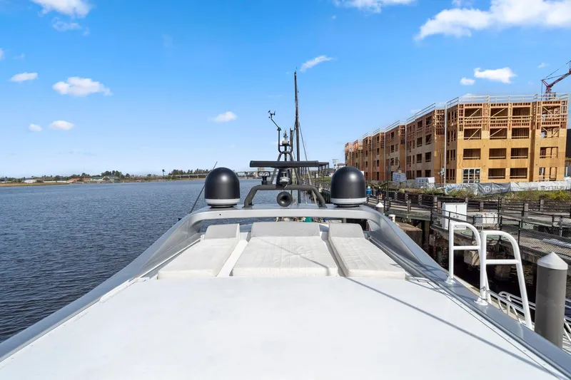 Slide: The Image of Mangusta 72 Express yacht docked by waterfront construction, clear sky, 2010 model. - 14