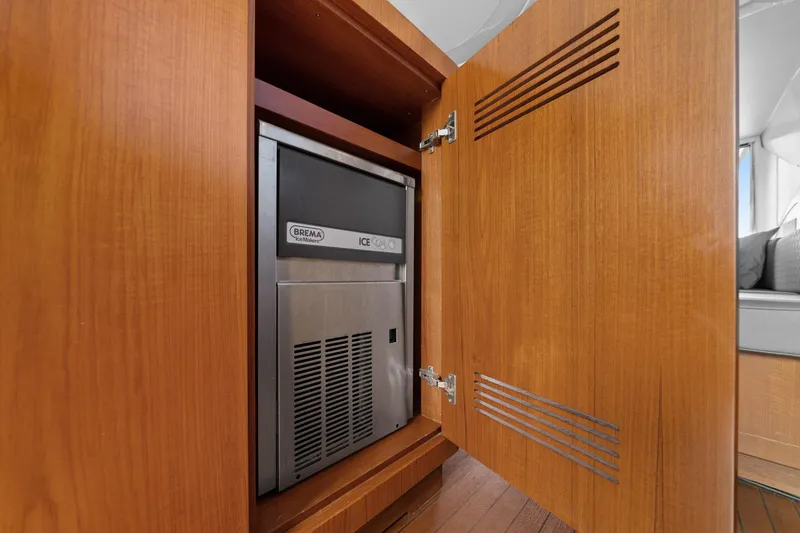 Slide: The Image of Built-in ice maker in wooden cabinet on 2010 Mangusta 72 Express yacht. - 21