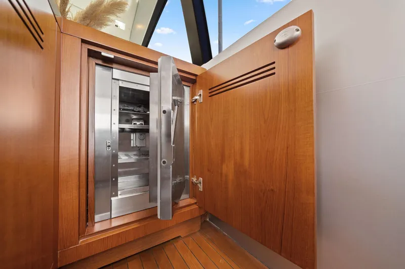Slide: The Image of Wooden cabinet with open stainless steel safe inside, aboard 2010 Mangusta 72 Express yacht. - 22