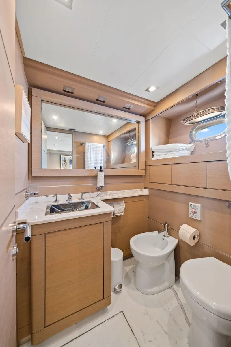 Slide: The Image of Luxurious bathroom interior of 2010 Mangusta 72 Express yacht with modern fixtures and wood accents. - 33