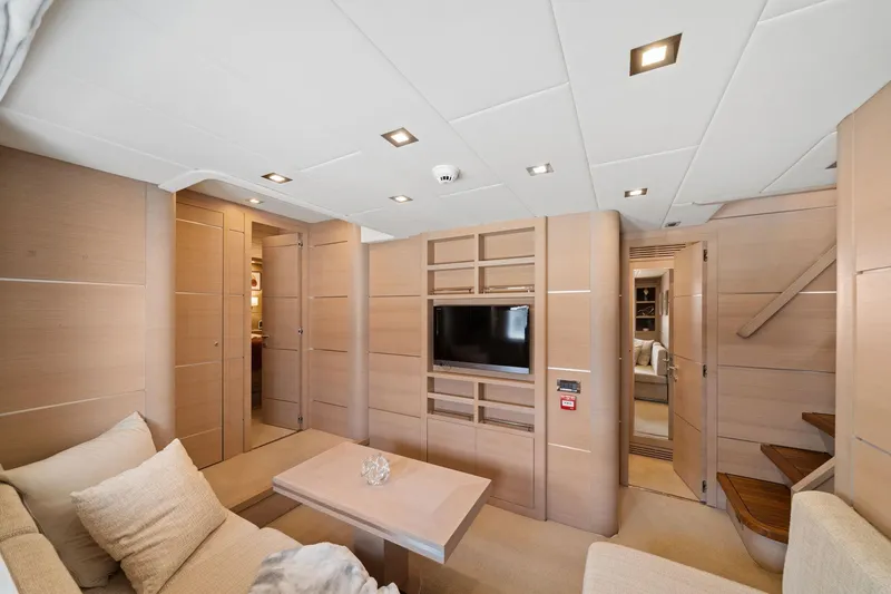 Slide: The Image of Luxurious interior of 2010 Mangusta 72 Express yacht with modern furnishings and built-in TV. - 39