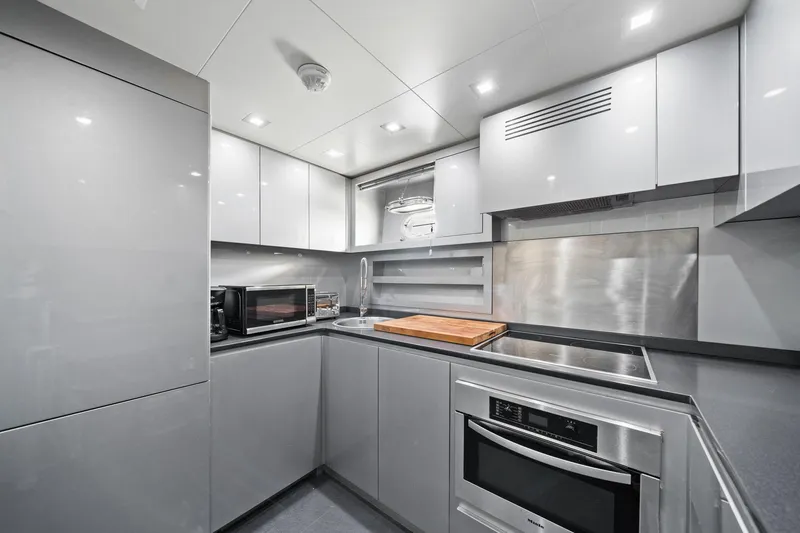 Slide: The Image of Modern kitchen interior in 2010 Mangusta 72 Express yacht, featuring sleek cabinetry and appliances. - 47