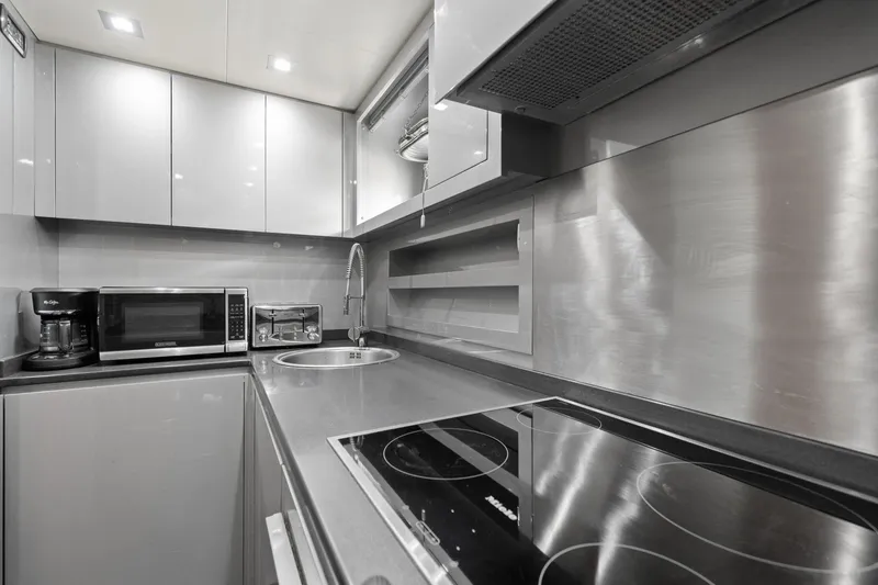 Slide: The Image of Modern kitchen in 2010 Mangusta 72 Express yacht with sleek appliances and stainless steel finishes. - 48