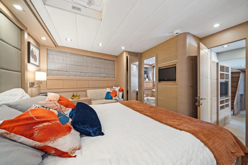 Slide: The Image of Luxurious bedroom interior of 2010 Mangusta 72 Express yacht with modern decor and vibrant pillows. - 52