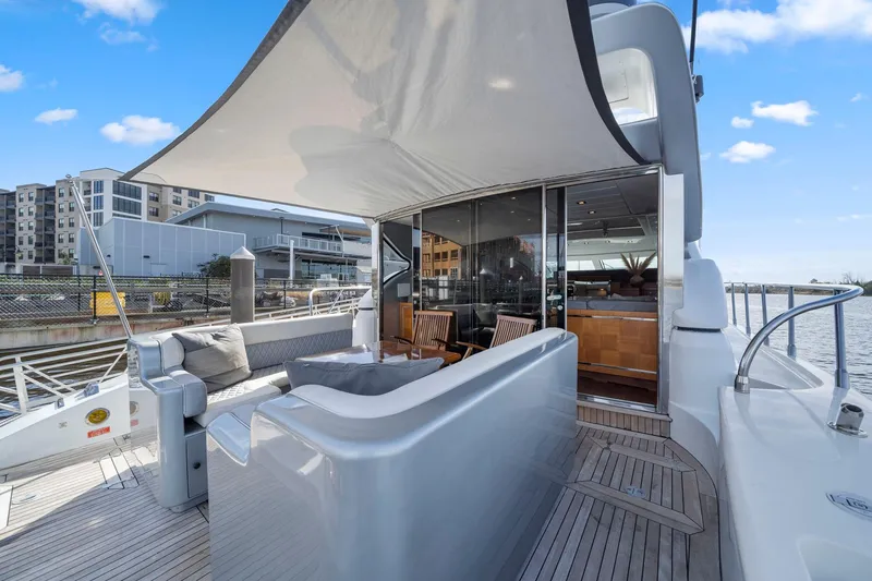 Slide: The Image of Luxurious 2010 Mangusta 72 Express yacht with elegant outdoor seating and modern design. - 7