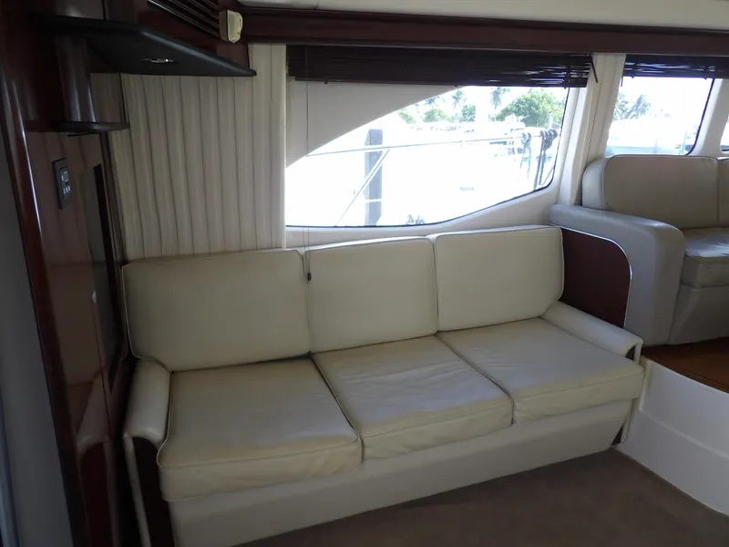 Slide: The Image of 2008 Sea Ray 44 Sedan Bridge interior with cream leather sofa. - 13