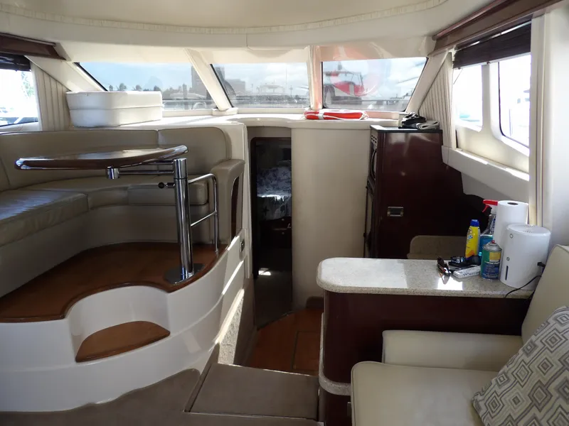 Slide: The Image of Interior of 2008 Sea Ray 44 Sedan Bridge yacht with modern seating and windows. - 16