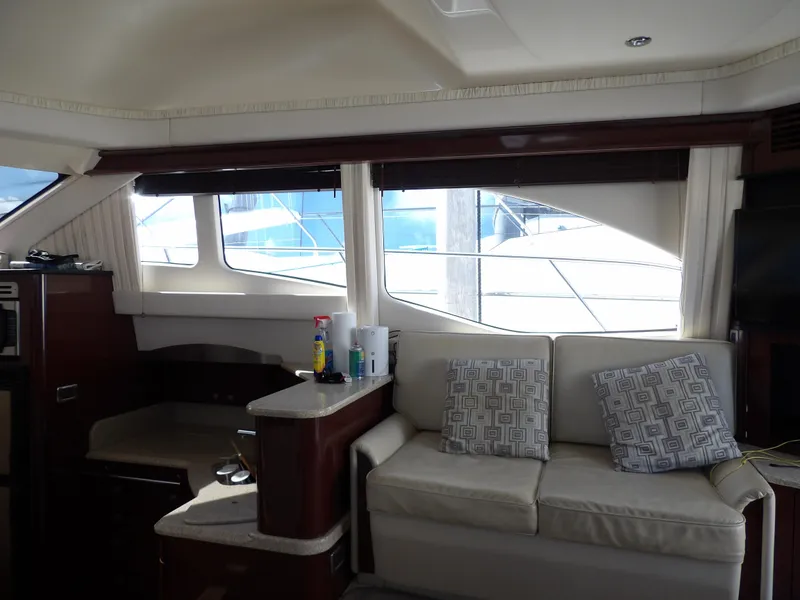 Slide: The Image of Interior of 2008 Sea Ray 44 Sedan Bridge yacht with sofa and windows. - 18