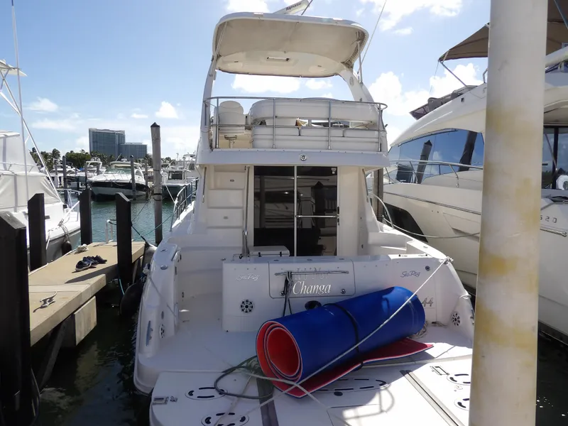 Slide: The Image of 2008 Sea Ray 44 Sedan Bridge yacht docked at marina, rear view. - 2