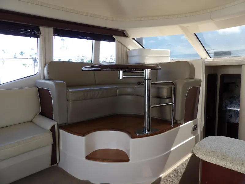 Slide: The Image of Luxurious interior of 2008 Sea Ray 44 Sedan Bridge yacht with leather seating and table. - 25