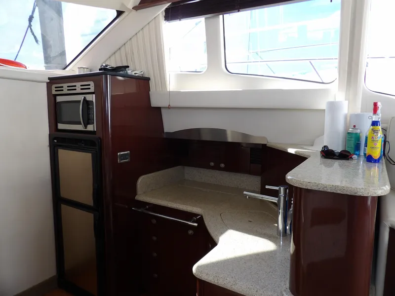 Slide: The Image of 2008 Sea Ray 44 Sedan Bridge yacht kitchen with modern appliances and sleek countertops. - 30
