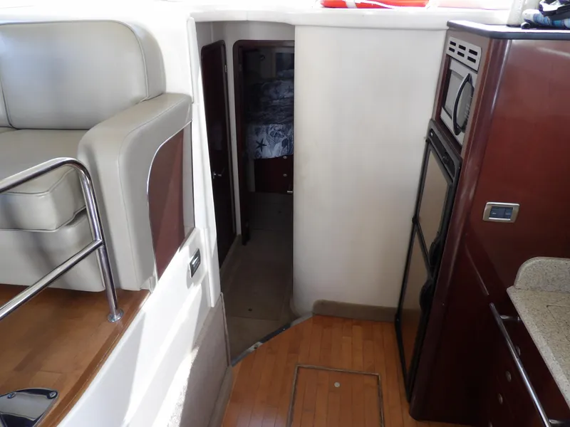 Slide: The Image of Interior of 2008 Sea Ray 44 Sedan Bridge yacht, featuring kitchen and seating area. - 33