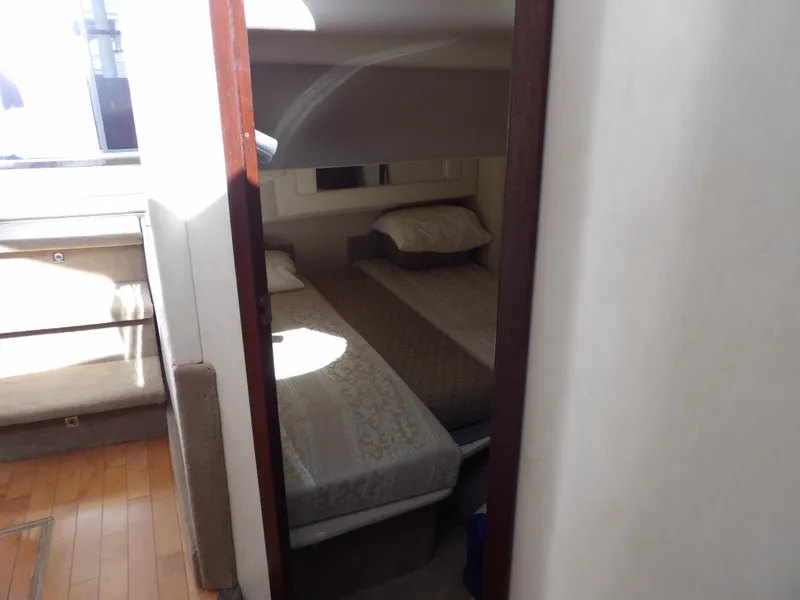 Slide: The Image of 2008 Sea Ray 44 Sedan Bridge cabin with twin beds and wooden flooring. - 35