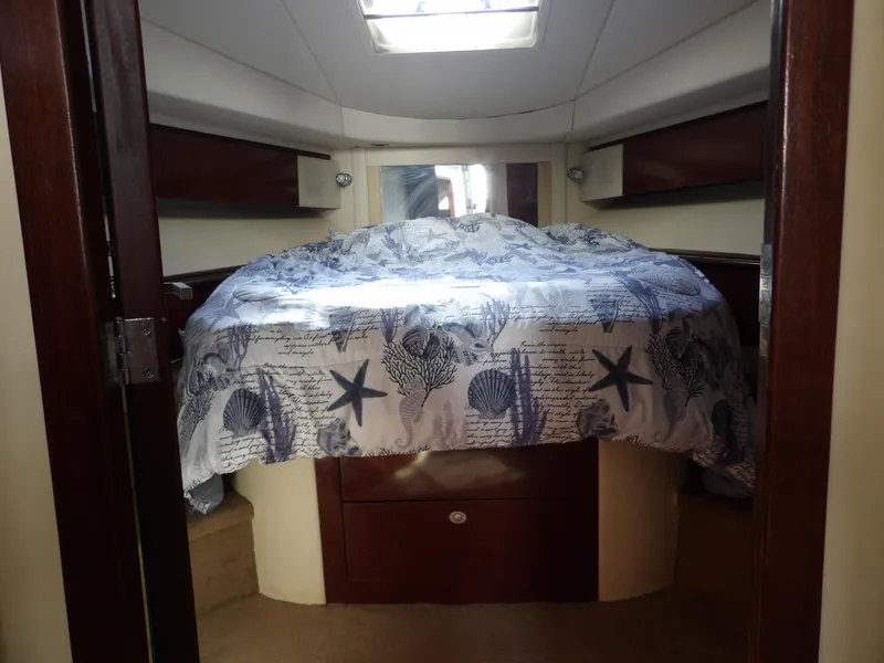Slide: The Image of 2008 Sea Ray 44 Sedan Bridge cabin with nautical-themed bedding. - 45