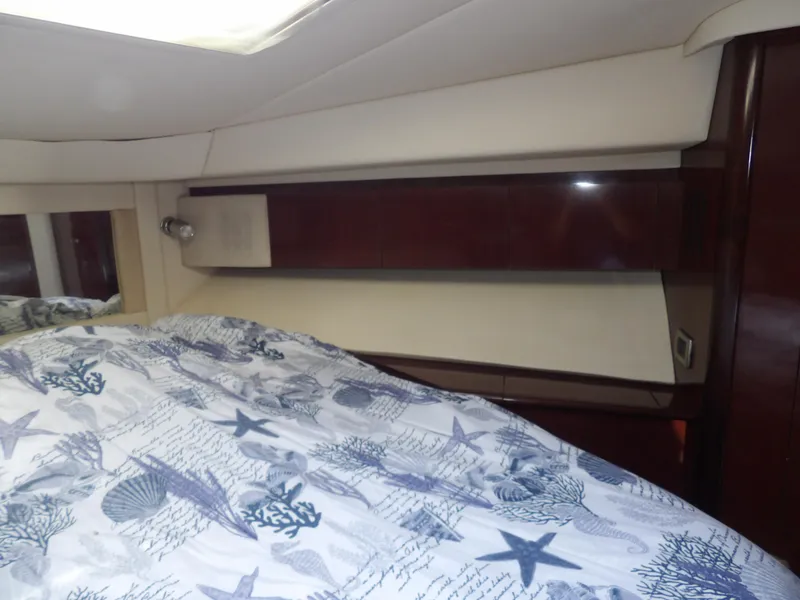 Slide: The Image of 2008 Sea Ray 44 Sedan Bridge cabin interior with nautical-themed bedding. - 49