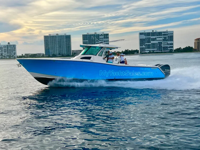 The Image of 2012 Grady-White Canyon 366 boat cruising on water with cityscape background. - 0