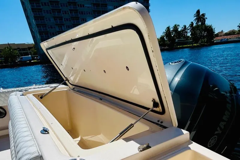 Slide: The Image of 2012 Grady-White Canyon 366 boat with open storage compartment by the water. - 11