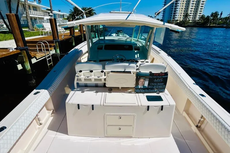 Slide: The Image of 2012 Grady-White Canyon 366 boat docked by waterfront homes. - 13