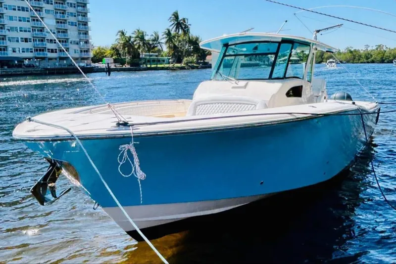 Slide: The Image of 2012 Grady-White Canyon 366 boat docked on a sunny day. - 2