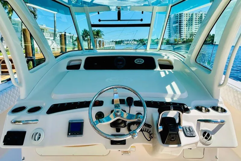 Slide: The Image of 2012 Grady-White Canyon 366 helm with modern controls and waterfront view. - 23