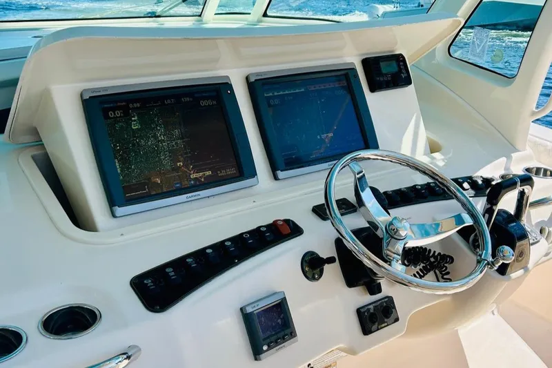 Slide: The Image of 2012 Grady-White Canyon 366 helm with dual navigation screens and steering wheel. - 25