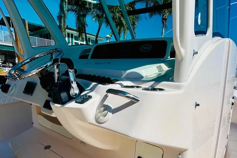 Slide: The Image of 2012 Grady-White Canyon 366 boat helm with steering wheel and controls. - 26