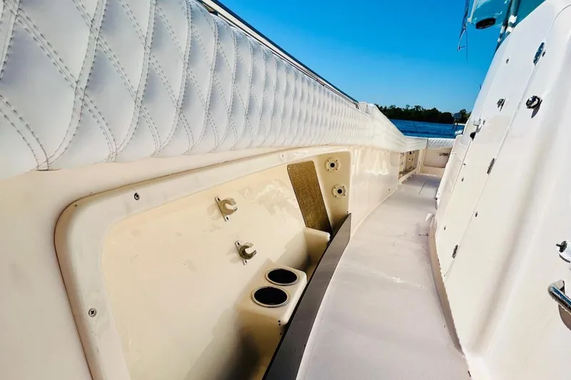 Slide: The Image of Interior view of 2012 Grady-White Canyon 366 boat, featuring cushioned seating and cup holders. - 32