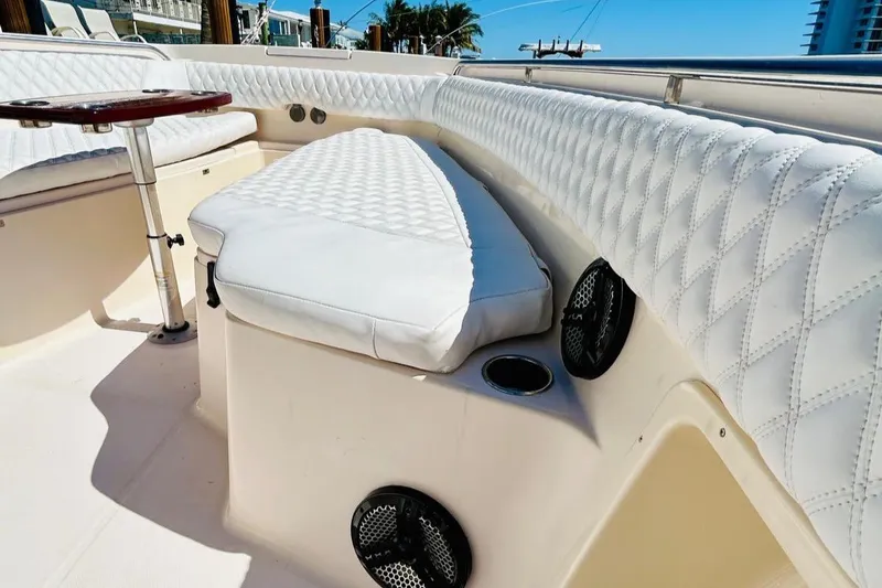 Slide: The Image of 2012 Grady-White Canyon 366 boat interior with white quilted seating and cup holders. - 36