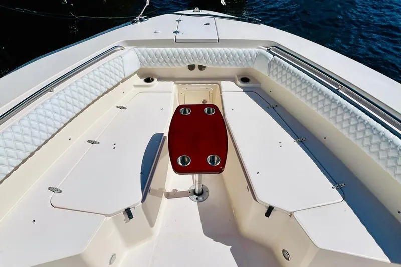 Slide: The Image of 2012 Grady-White Canyon 366 boat interior with cushioned seating and central table. - 37