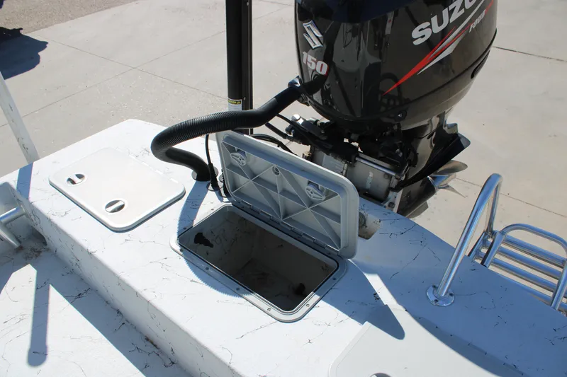 Slide: The Image of 2015 Shoalwater 20 Catamaran with Suzuki 150 engine and open storage compartment. - 11