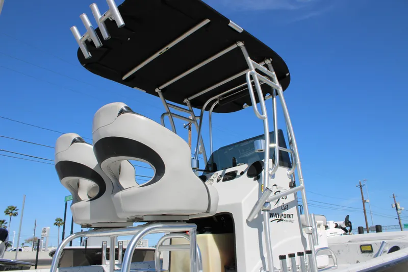 Slide: The Image of 2015 Shoalwater 20 Catamaran with elevated seating and canopy against clear blue sky. - 15