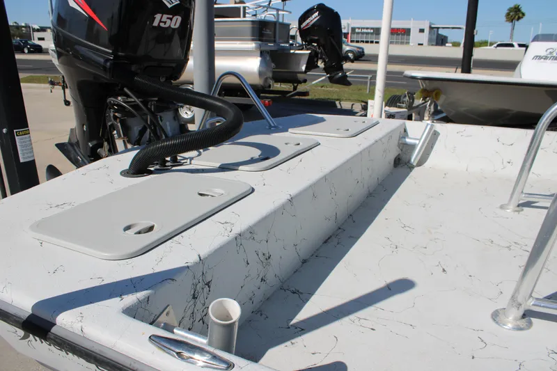 Slide: The Image of 2015 Shoalwater 20 Catamaran boat deck with motor and storage compartments. - 16