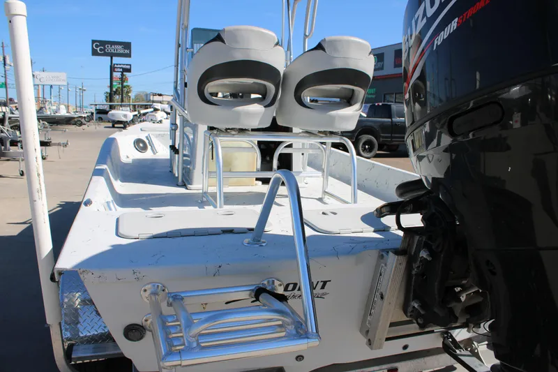 Slide: The Image of 2015 Shoalwater 20 Catamaran with Suzuki outboard motor, docked in a marina. - 4