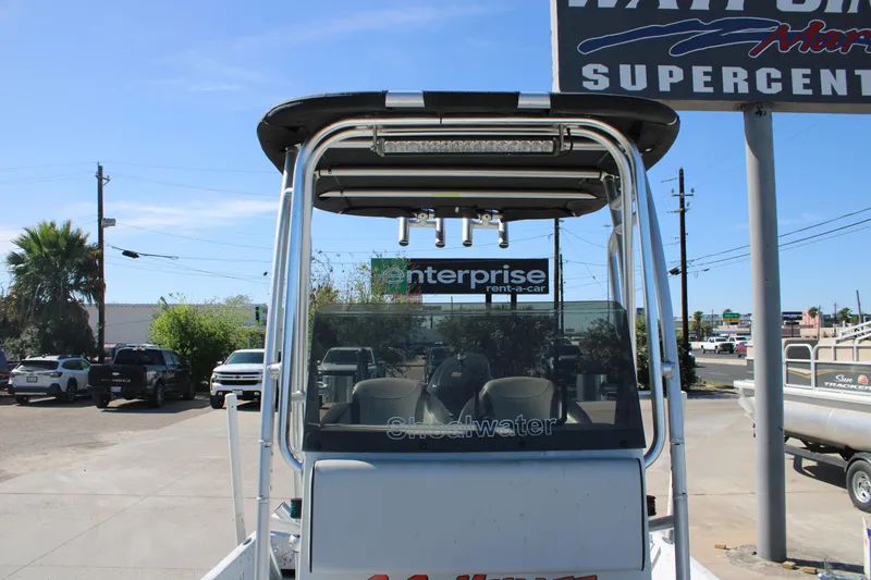 Slide: The Image of 2015 Shoalwater 20 Catamaran boat at dealership, front view with signage in background. - 8