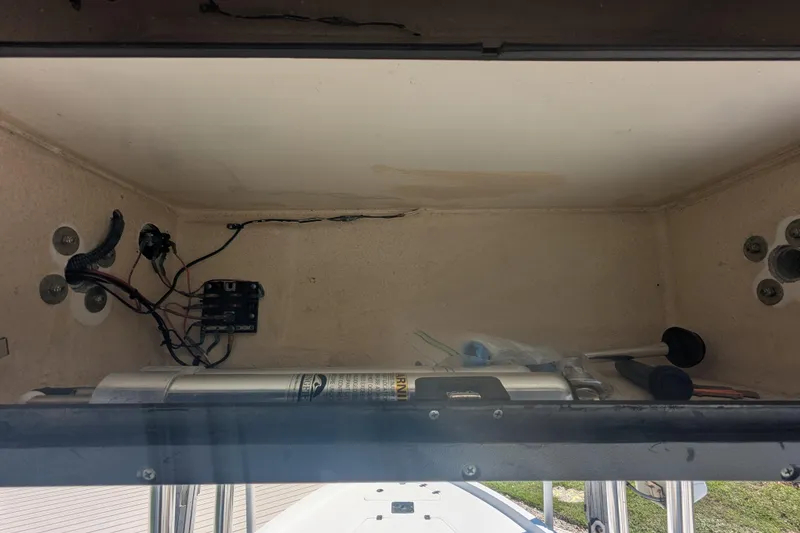 Slide: The Image of Storage compartment of a 2012 Key West 216 Bay Reef boat with wiring and tools. - 10