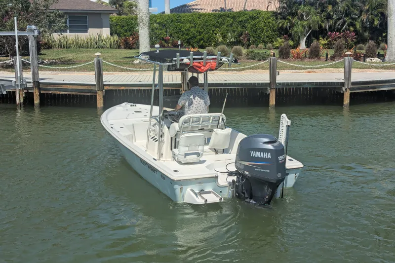 Slide: The Image of 2012 Key West 216 Bay Reef boat with Yamaha engine on calm water near dock. - 4