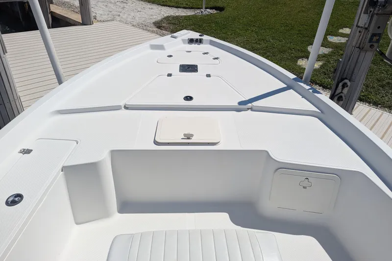Slide: The Image of 2012 Key West 216 Bay Reef boat deck with storage compartments and seating. - 5