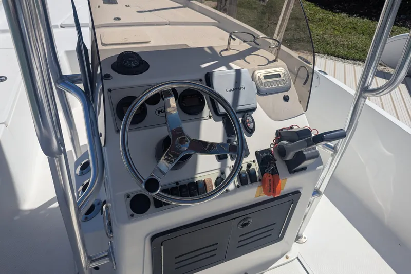 Slide: The Image of 2012 Key West 216 Bay Reef boat console with steering wheel and Garmin navigation system. - 7