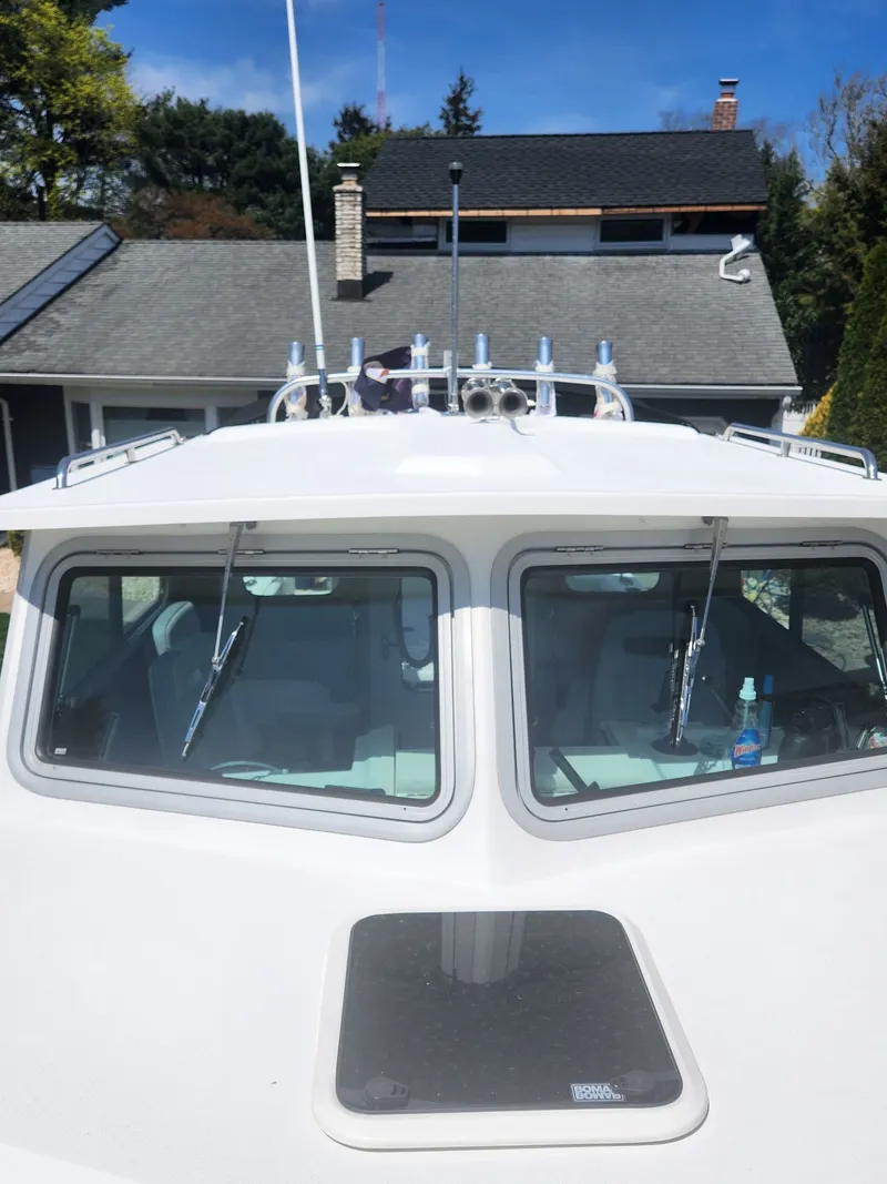 Slide: The Image of Parker 2520 XLD Sport Cabin 2022 with open storage and engines. - 14