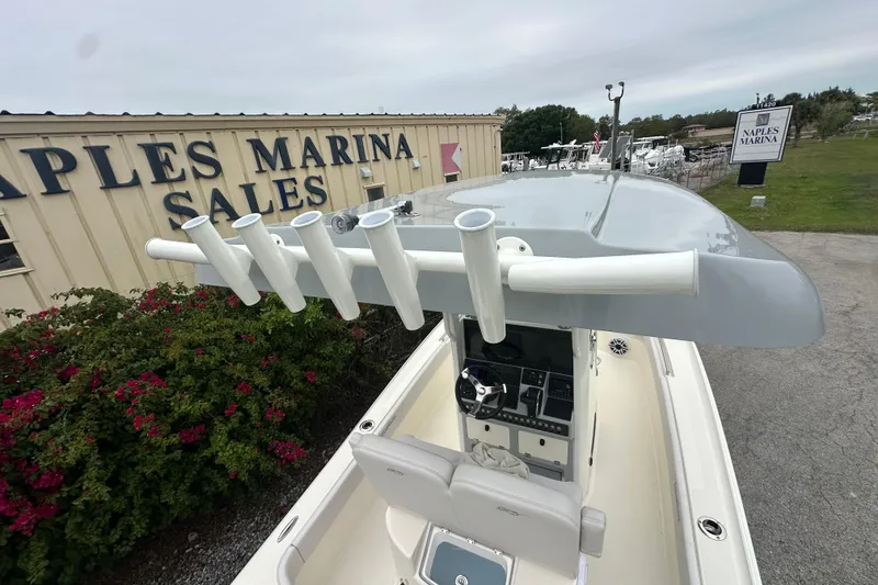 Slide: The Image of 2026 ShearWater 260 SS Carolina boat at Naples Marina Sales, featuring rod holders and console. - 10