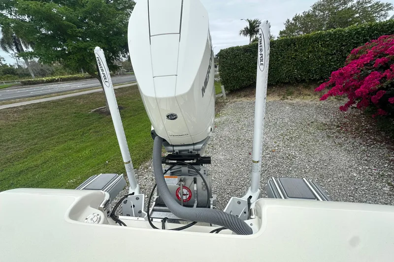 Slide: The Image of 2026 ShearWater 260 SS Carolina boat engine with Power-Pole anchors, parked outdoors. - 14