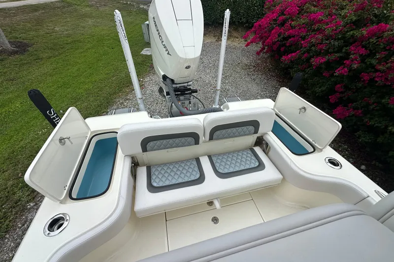 Slide: The Image of 2026 ShearWater 260 SS Carolina boat with open storage compartments and Mercury engine. - 15