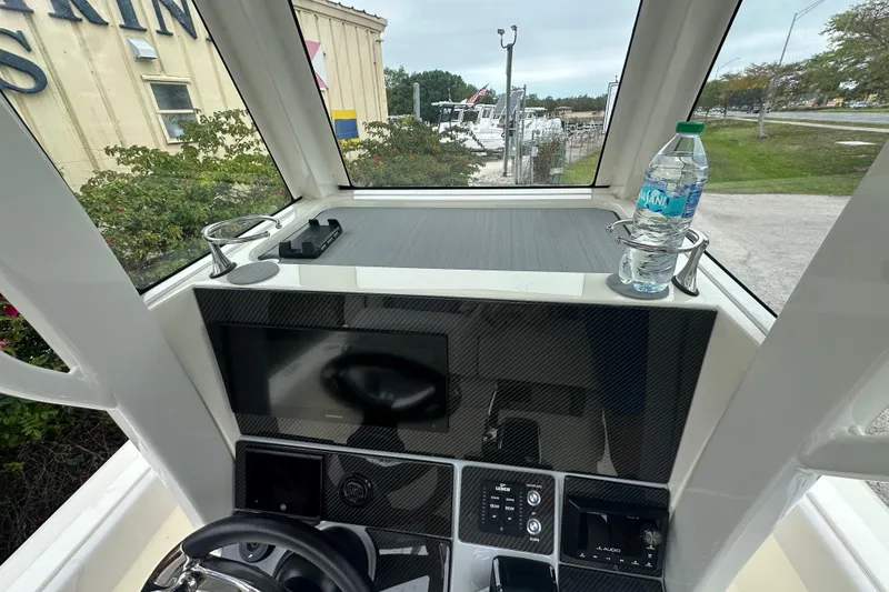Slide: The Image of Interior view of 2026 ShearWater 260 SS Carolina boat dashboard with modern controls. - 17